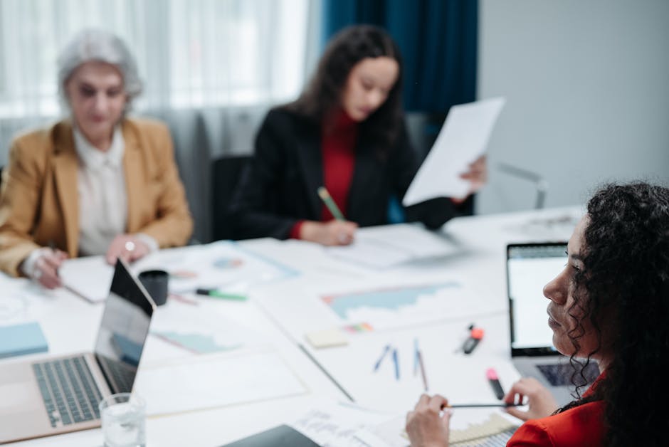 Business professionals collaborating around a table for a corporate strategy meeting.